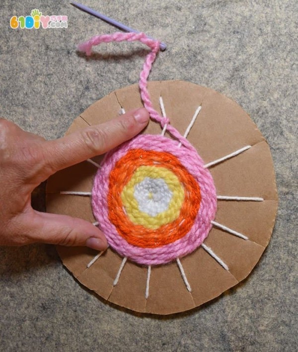 Handmade beautiful sunset from waste cardboard and yarn