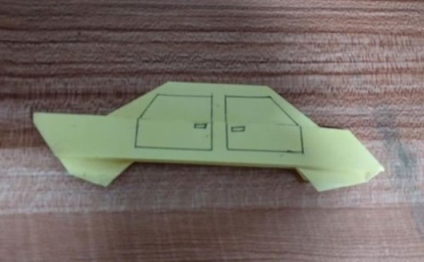 Simple handmade origami illustration of how to fold a car