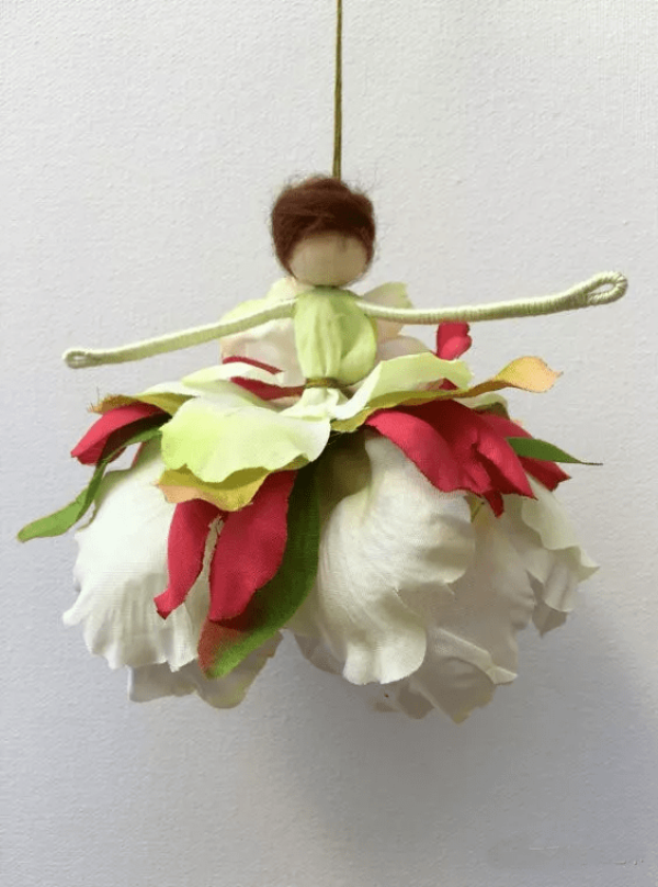 She took apart the old fabric artificial flowers piece by piece and made such a beautiful flower doll. It’s amazing.