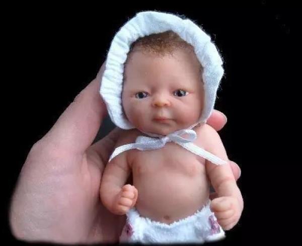 The cute sculpture Baby in the palm of your hand