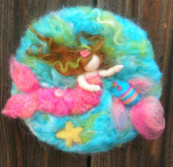 DIY mermaid made from wool felt happily playing at the bottom of the sea