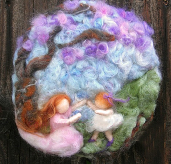 Children playing happily under the wool felt DIY tree