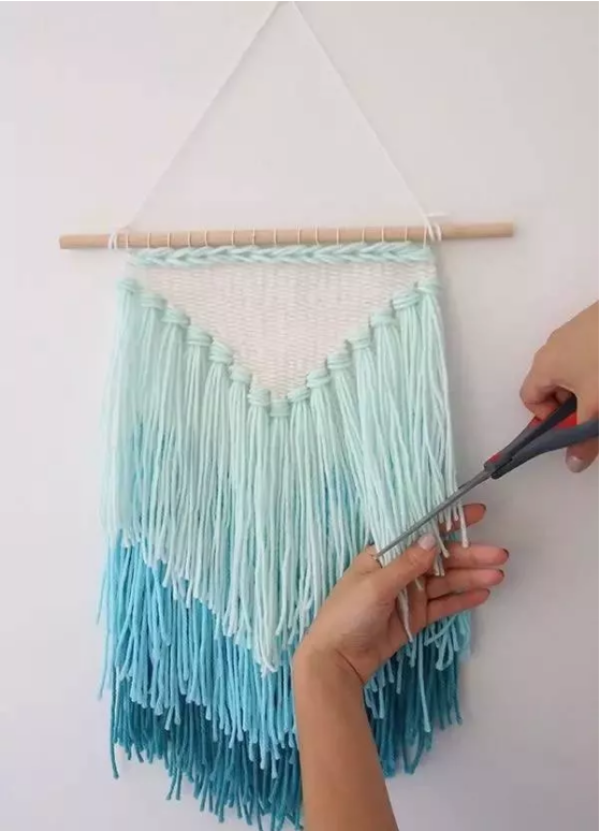 Tutorial illustration of a DIY hand-woven wall tassel art tapestry