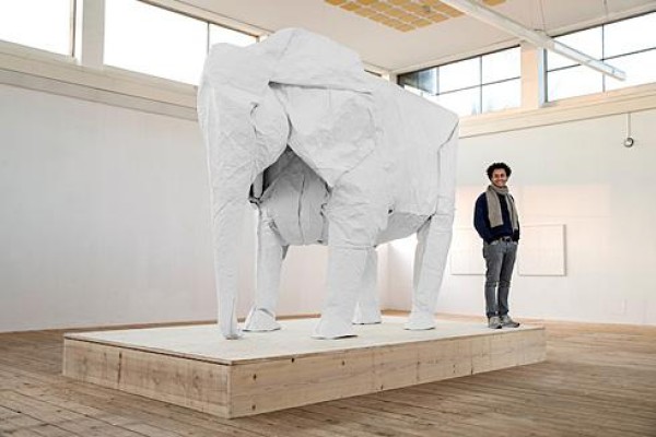 Talented artist Sipho Mabona folds a life-size elephant from a piece of white paper