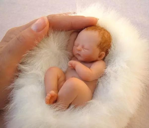 The cute sculpture Baby in the palm of your hand