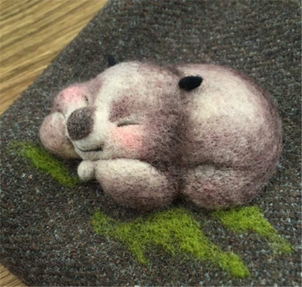 DIY handmade cute little brown bear made from handmade wool felt that fell asleep