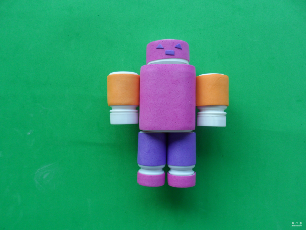 Isn’t this little robot cute? Cute childrens toy robot made from discarded pill bottles and colorful sponge paper