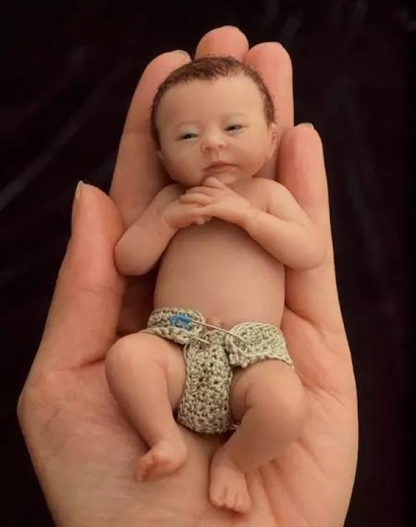 The cute sculpture Baby in the palm of your hand