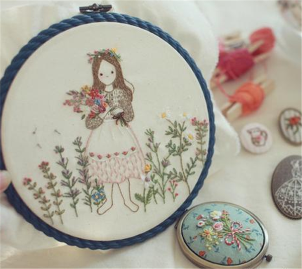 Beautiful little girl holding flowers in fabric embroidery DIY