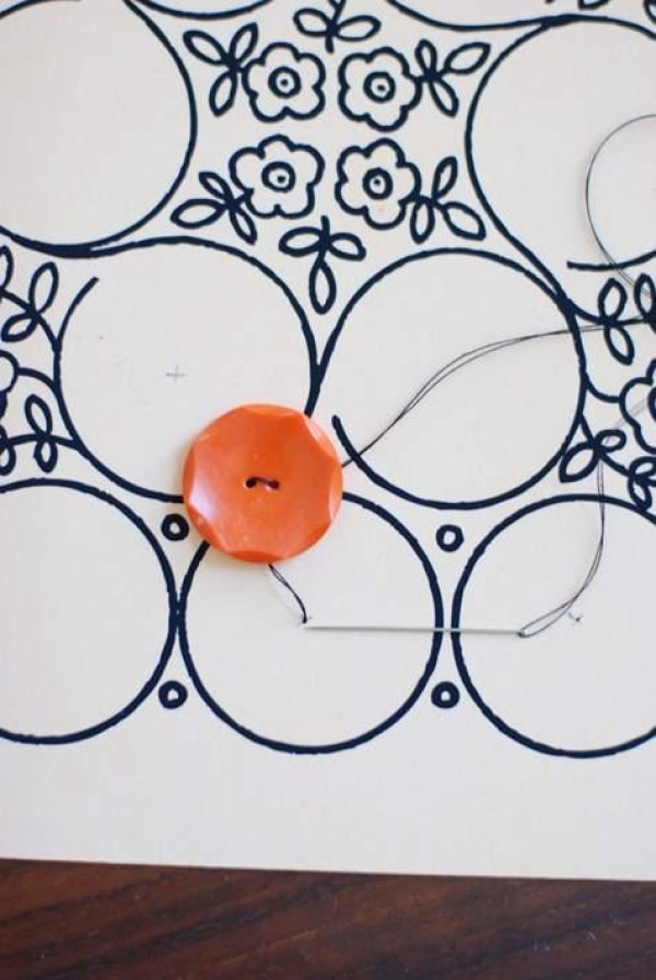 A simple DIY mural is completed with just a few strokes of buttons and pens.