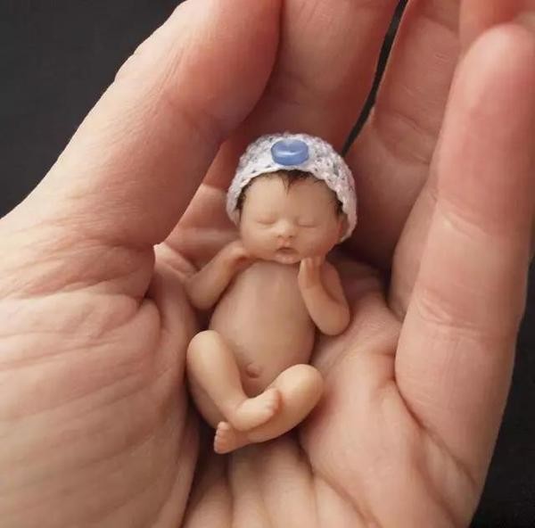 The cute sculpture Baby in the palm of your hand