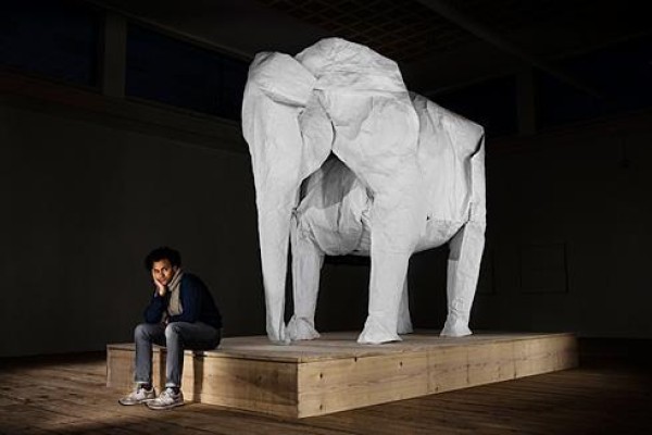 Talented artist Sipho Mabona folds a life-size elephant from a piece of white paper