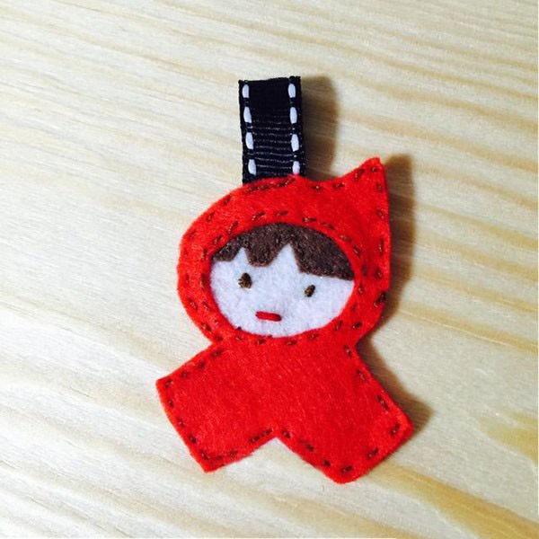 The brave little hero’s cute little red riding hood is made into a keychain