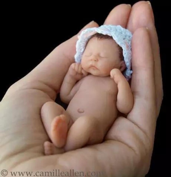 The cute sculpture Baby in the palm of your hand