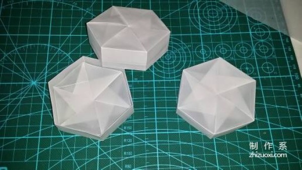 Illustration of the manual origami process of a simplified hexagonal box