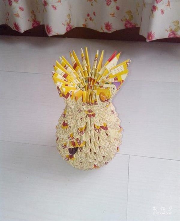 Detailed illustrated tutorial for hand-making triangular vase from discarded advertising paper