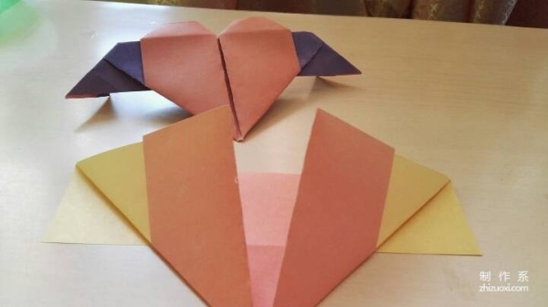 A handmade origami heart with wings - tutorial on how to make origami hearts