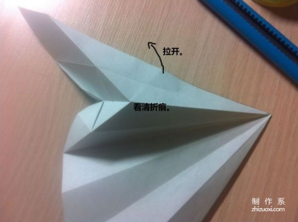 Origami illustration tutorial on folding a swan with spread wings