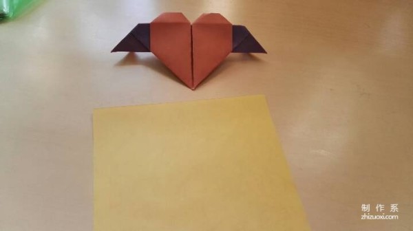 A handmade origami heart with wings - tutorial on how to make origami hearts