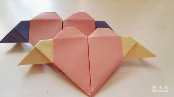 A handmade origami heart with wings - tutorial on how to make origami hearts