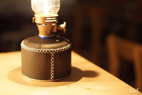 Use the cross stitch method to sew a gas lamp can cover