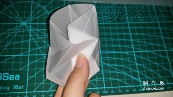 Illustration of the manual origami process of a simplified hexagonal box