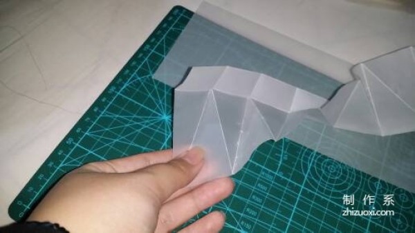 Illustration of the manual origami process of a simplified hexagonal box