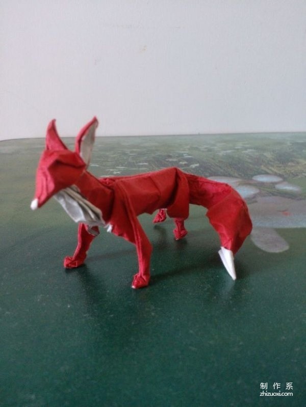 Illustrated origami tutorial for folding a three-dimensional little fox