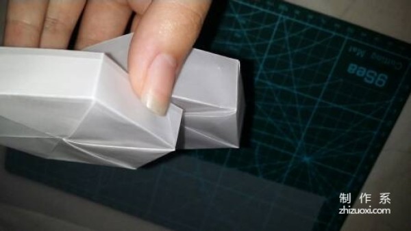 Illustration of the manual origami process of a simplified hexagonal box