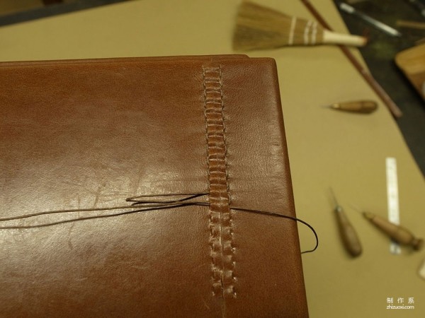 The process of Japanese craftsman Yukihiro Fujii making a leather suitcase based on a wooden box frame