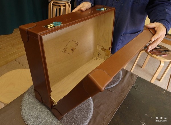 The process of Japanese craftsman Yukihiro Fujii making a leather suitcase based on a wooden box frame