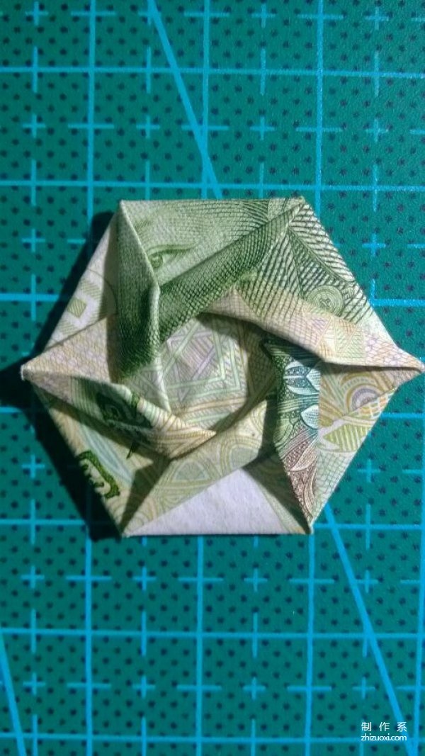 Illustration of the manual origami tutorial method of how to fold a hexagonal badge