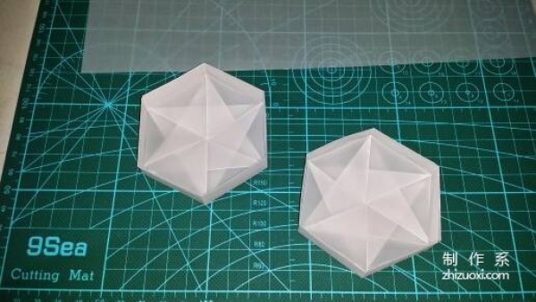 Illustration of the manual origami process of a simplified hexagonal box