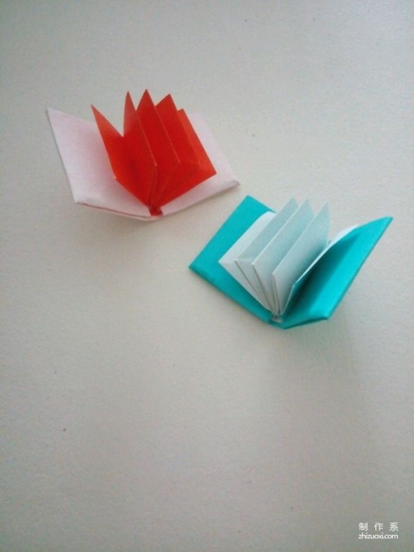 A creative origami real-life tutorial on a mini three-dimensional book-shaped book that can be folded out of just one piece of paper