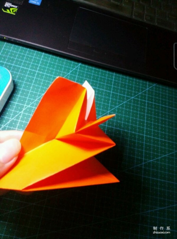 Origami method of folding a paper bird, real-life tutorial on origami of a small kingfisher