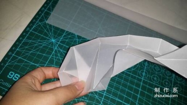 Illustration of the manual origami process of a simplified hexagonal box