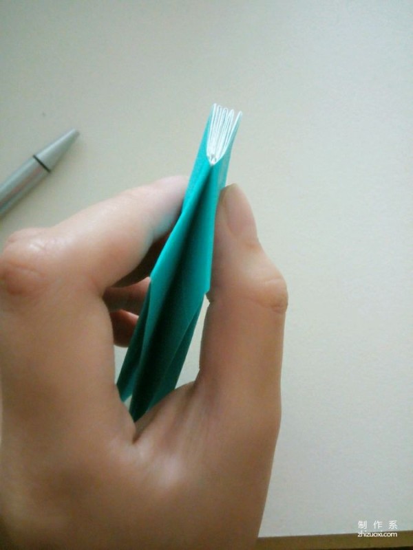 A creative origami real-life tutorial on a mini three-dimensional book-shaped book that can be folded out of just one piece of paper