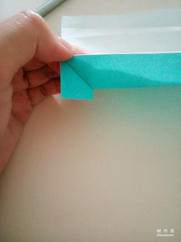 A creative origami real-life tutorial on a mini three-dimensional book-shaped book that can be folded out of just one piece of paper