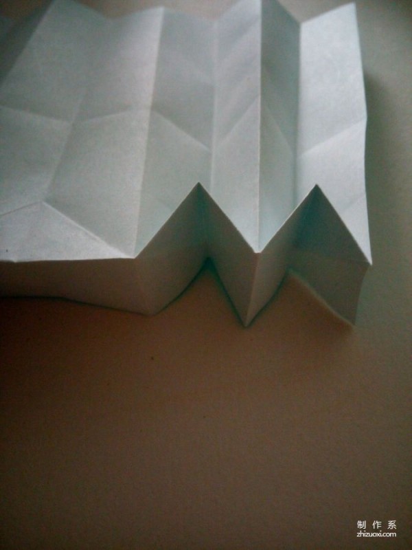 A creative origami real-life tutorial on a mini three-dimensional book-shaped book that can be folded out of just one piece of paper