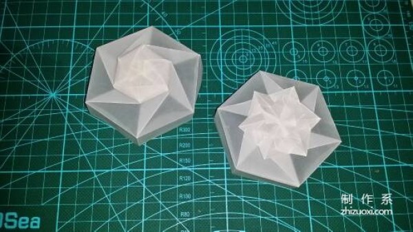 Illustration of the manual origami process of a simplified hexagonal box