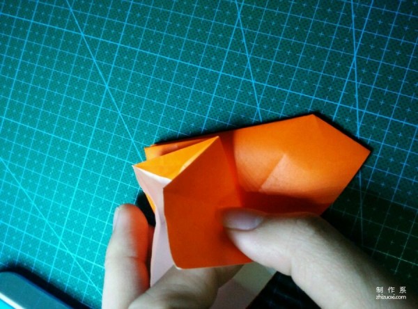 Origami method of folding a paper bird, real-life tutorial on origami of a small kingfisher