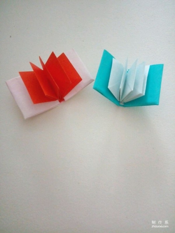 A creative origami real-life tutorial on a mini three-dimensional book-shaped book that can be folded out of just one piece of paper