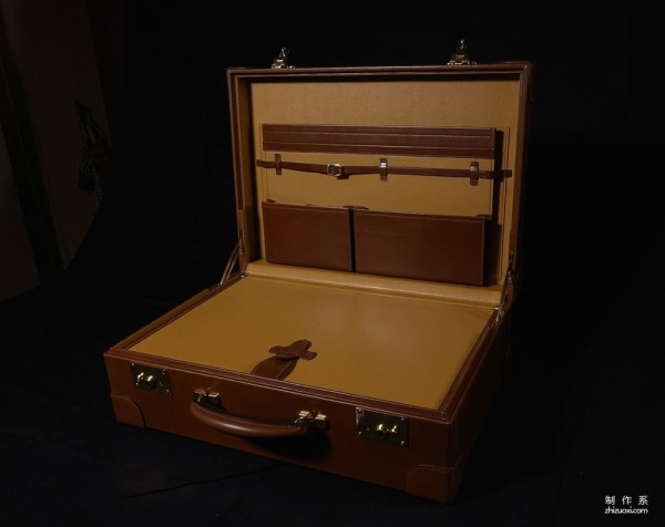 The process of Japanese craftsman Yukihiro Fujii making a leather suitcase based on a wooden box frame