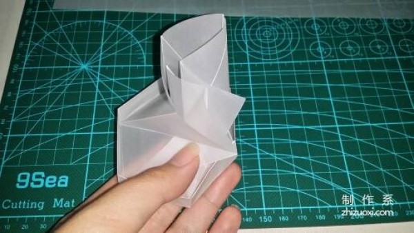 Illustration of the manual origami process of a simplified hexagonal box