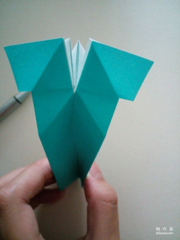 A creative origami real-life tutorial on a mini three-dimensional book-shaped book that can be folded out of just one piece of paper