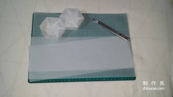 Illustration of the manual origami process of a simplified hexagonal box