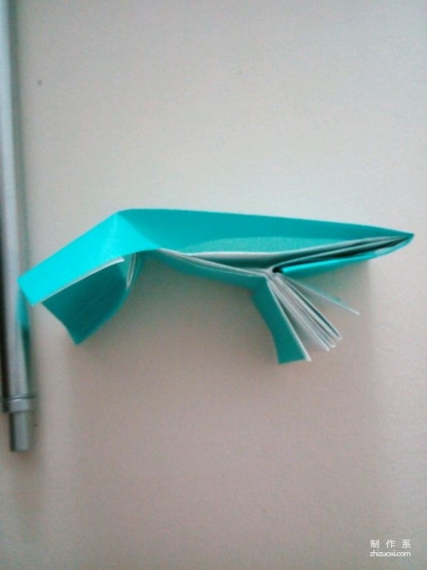 A creative origami real-life tutorial on a mini three-dimensional book-shaped book that can be folded out of just one piece of paper