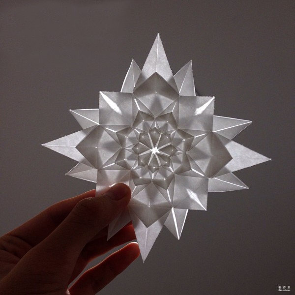 Origami illustrations and real-life tutorials on folding infinite geometric flowers using paper