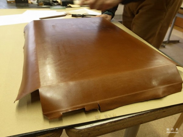 The process of Japanese craftsman Yukihiro Fujii making a leather suitcase based on a wooden box frame