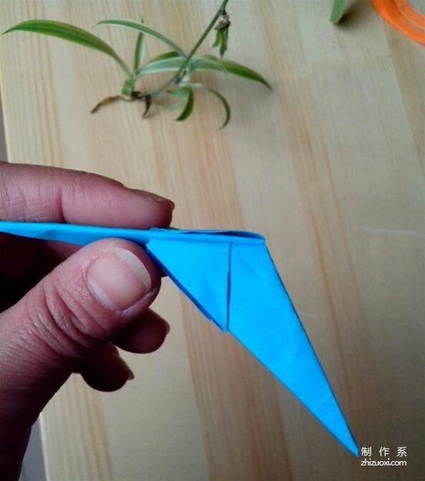 A tutorial on how to make a swallow-shaped paper airplane origami toy